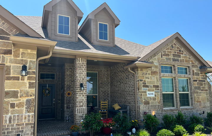The house's dormers and seamless gutter are perfectly installed.