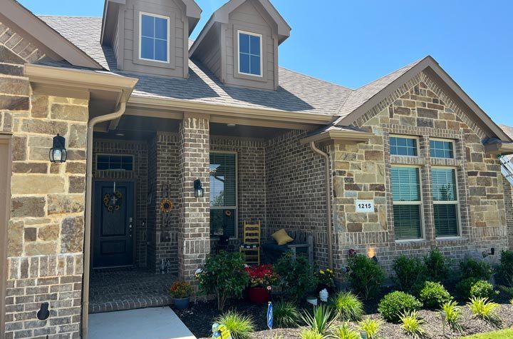The house's dormers and seamless gutter are perfectly installed.